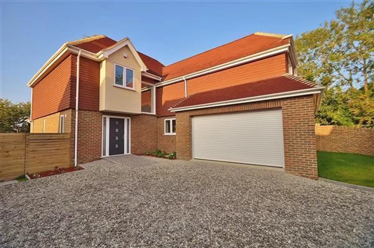 Completed detached home in Kent with brick and timber detailing and a double garage